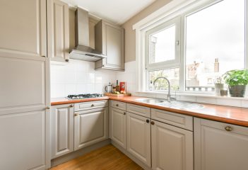 A,Sleek,,Modern,Kitchen,Showcasing,Minimalist,Cabinetry,,A,Stylish,Countertop,