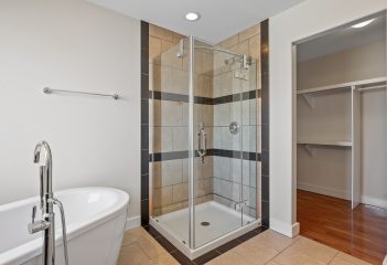 Bathroom,With,A,White,Tub,And,A,Shower,Stall.,The