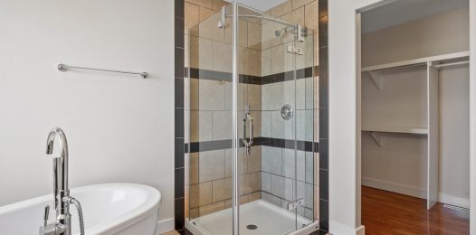 Bathroom,With,A,White,Tub,And,A,Shower,Stall.,The