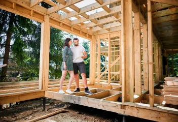 man-and-woman-inspecting-their-future-wooden-frame-2026-01-07-01-00-00-utc